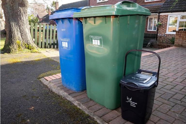 Blue wheelie bin, green wheelie bin and black food waste bin