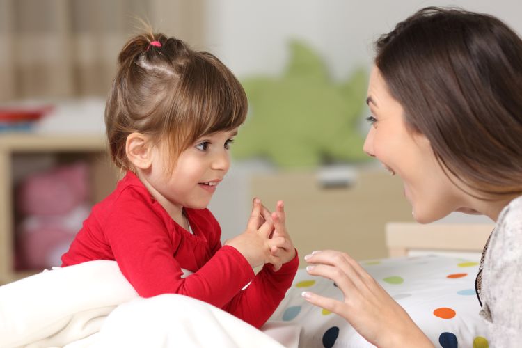 close up of toddler and mother playing together