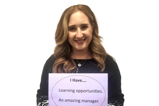 Social worker holding sign: "I have... learning opportunities and an amazing manager."