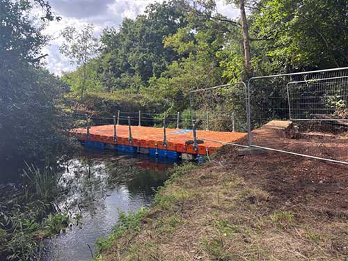 Red and blue pontoon bridge at Shepherd Meadows
