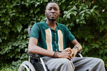 Young person in a park in a wheelchair
