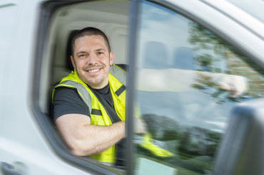 Man in vehicle wearing a high visibility jacket