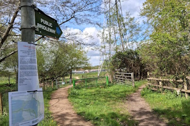 A bridleway at Horseshoe Lake. There is a new public bridleway finger post alongside temporary notices advertising the change.