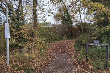 A tree-lined footpath with a sign which reads "Mosses Path".