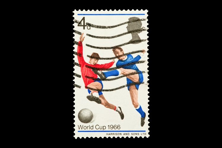 Vintage postage stamp showing two football players contesting the ball, overlaid with postal cancellation lines, with text “World Cup 1966” and a value of 4d