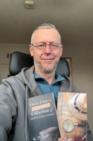 Author Peter Frost, posing with two of his books.