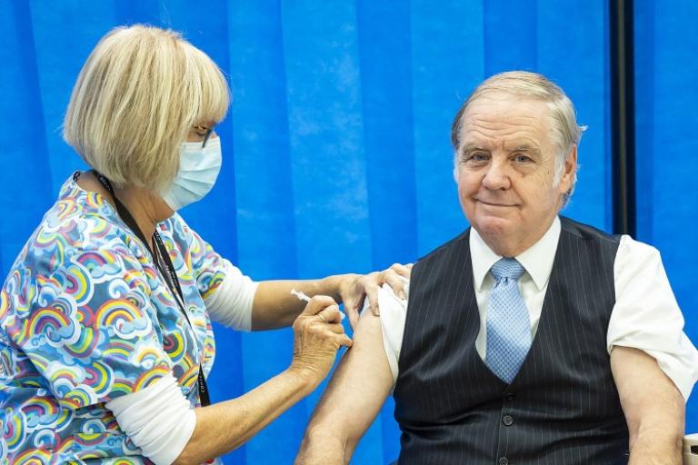 man getting flu vaccination, facing camera