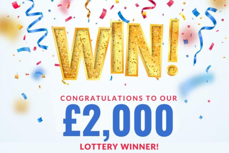 Confetti with wording saying:  "Win! Congratulations to our £2,000 lottery winner"