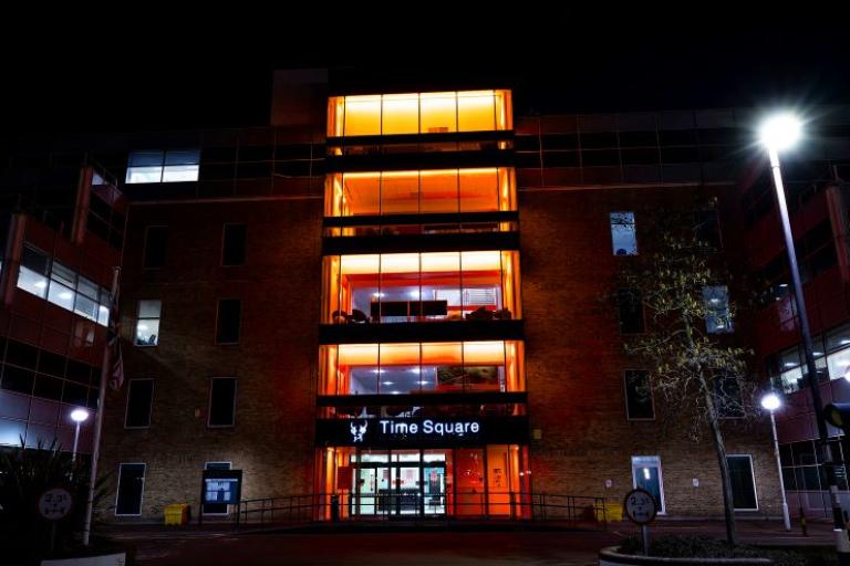 office building lit up with orange lights