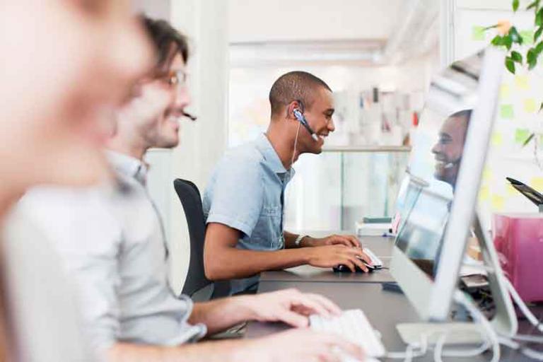 Professionals with headsets working at computers