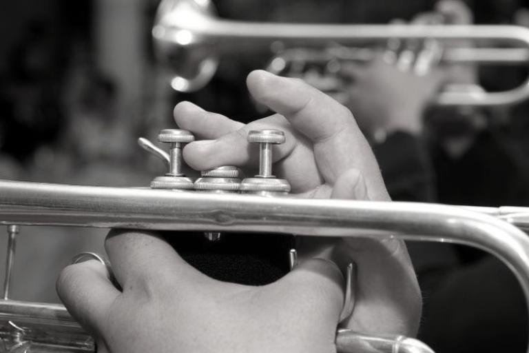 close up of hands playing a trumpet