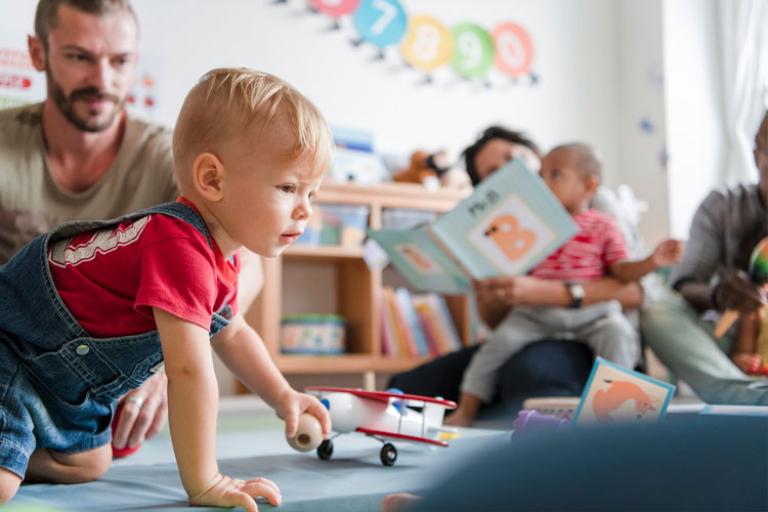 Child playing with a small ball in a playgroup