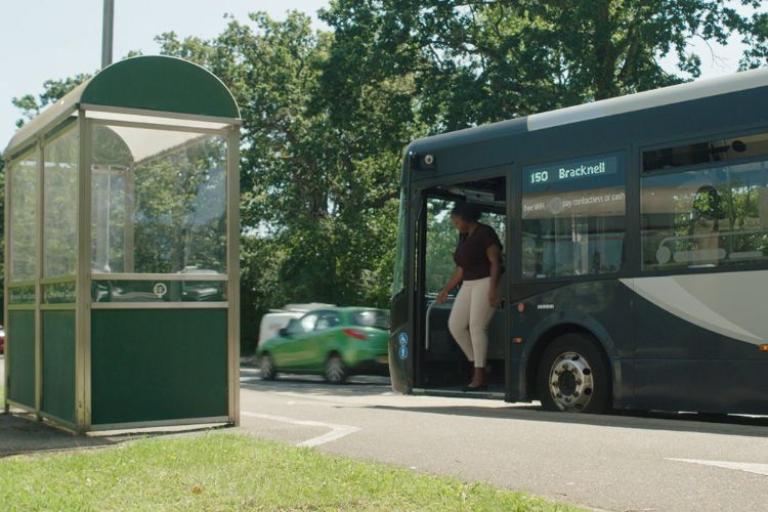 person getting off a bus at a bus stop