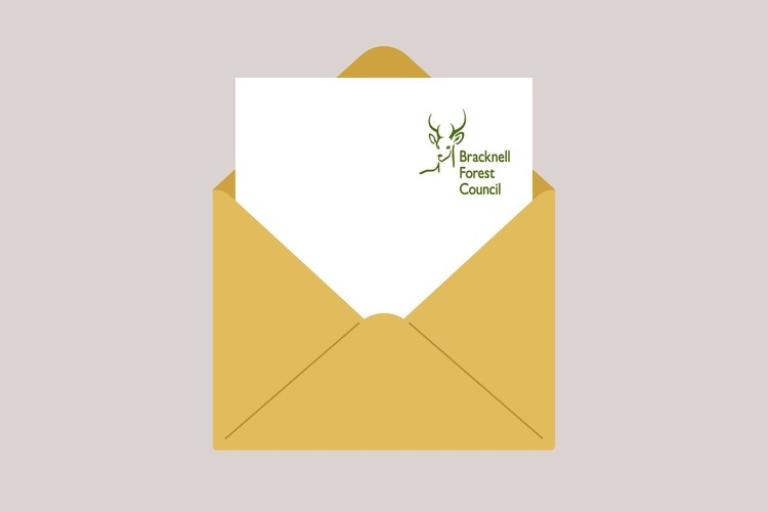 An open envelope with a letter coming out the top with the council's deer logo on 