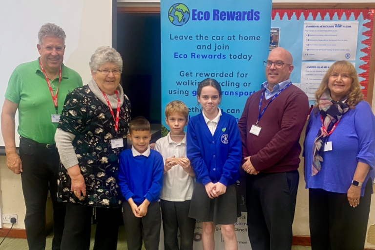 Image of three students and head teacher (Ian Garner) from Wooden Hill Primary School, with Cllr Mary Temperton and the Eco Rewards team.