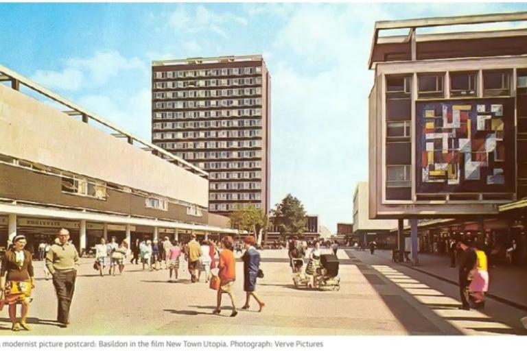 Modernist plaza with people walking, flanked by buildings including one with a colorful mural