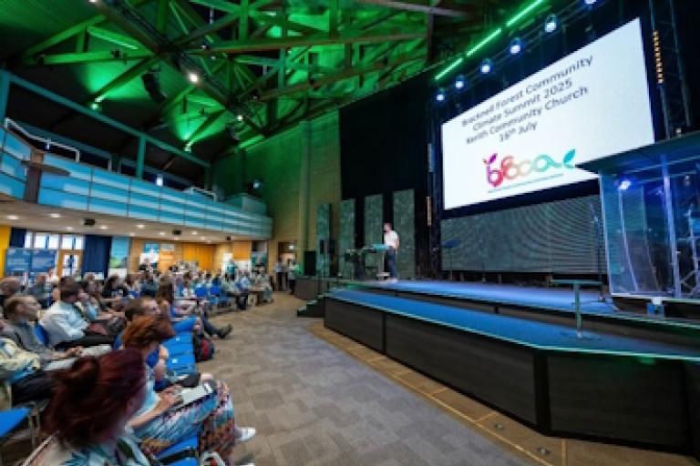 A crowd watches a speech at the Bracknell Forest Community Climate Summit 2025.