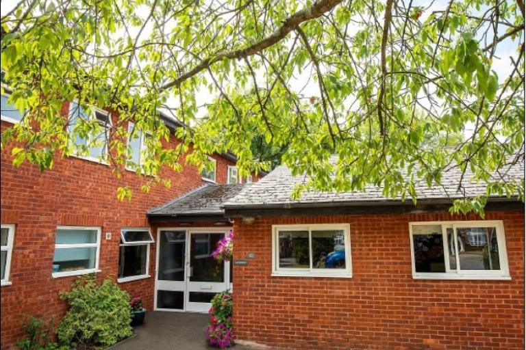 a brick building near a tree
