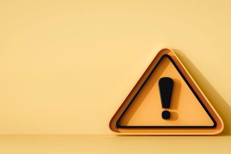 an orange warning triangle with black exclamation mark