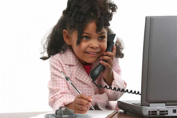 Child in business suit holding phone