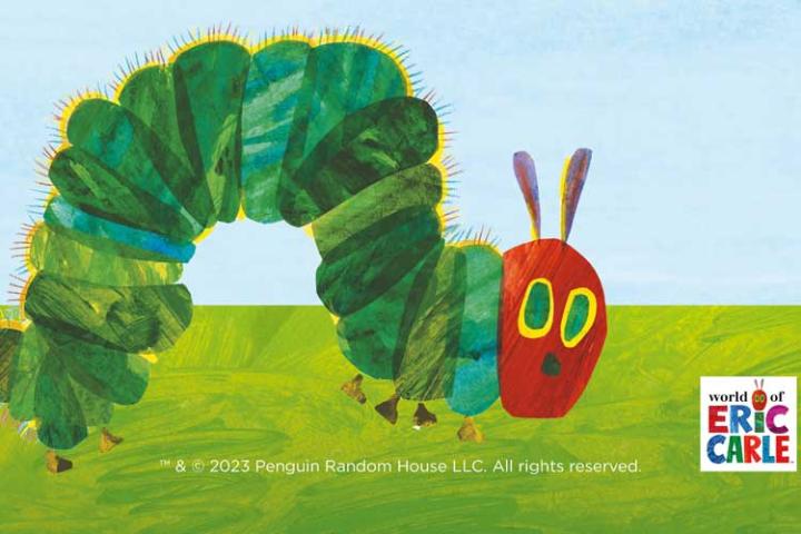 The Very Hungry Caterpillar crawling across the grass with Eric Carles name