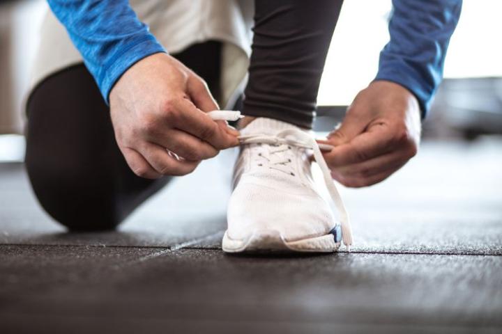 Person tying up shoe laces