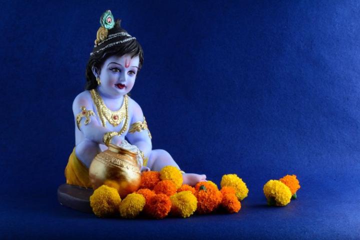 Krishna Janmashtami figure on a blue background