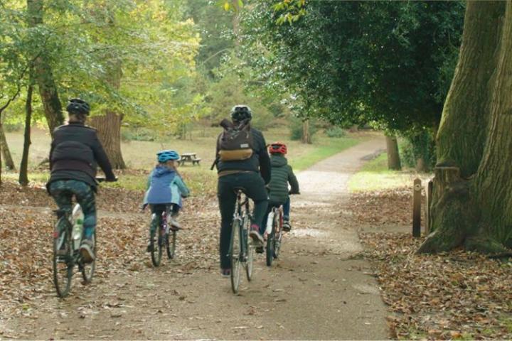 Family of four cycling through Lily Hill Park
