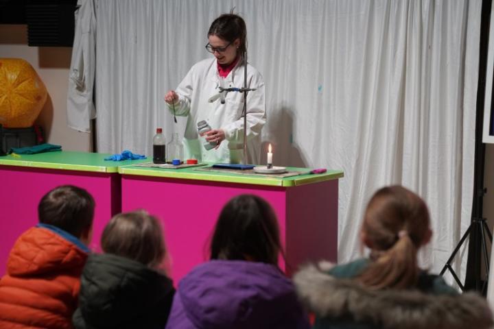 School girl in lab coat doing an experiment