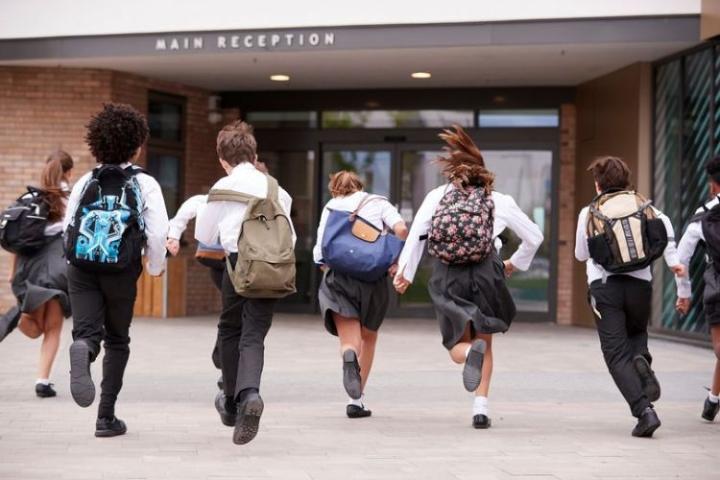 children running into a school