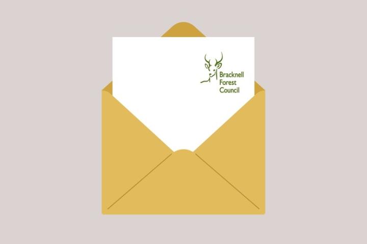 An open envelope with a letter coming out the top with the council's deer logo on 