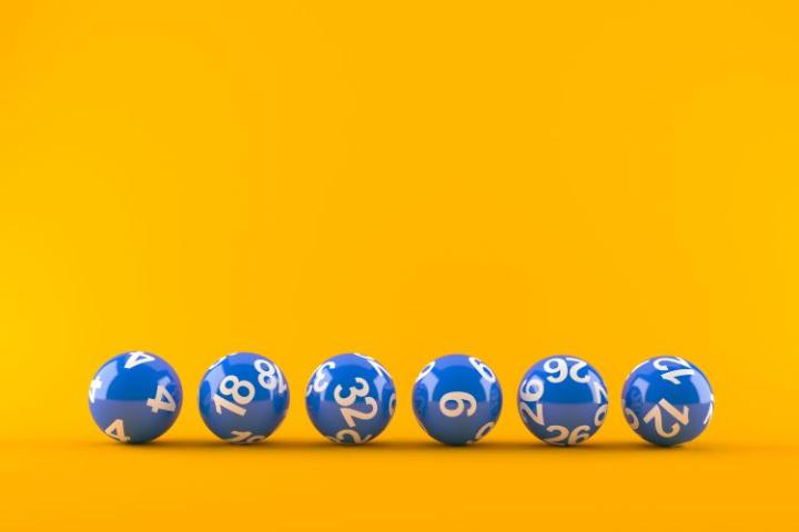 yellow background with 6 blue numbered lottery balls in a row