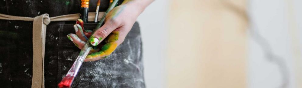 Hand holding a paint brush.