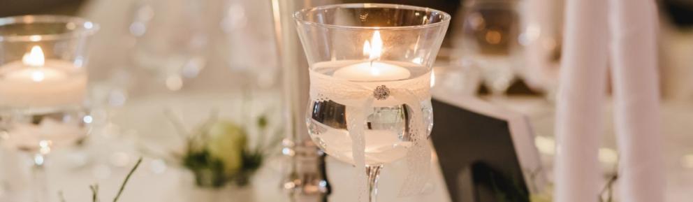 Decorated wine glass with a tea light inside.