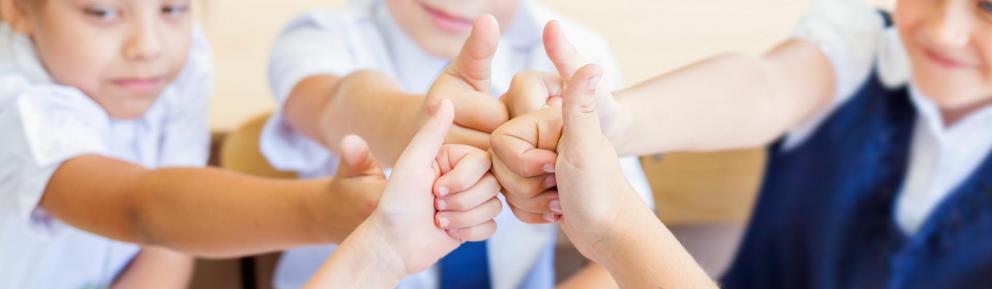 Children giving a thumbs up