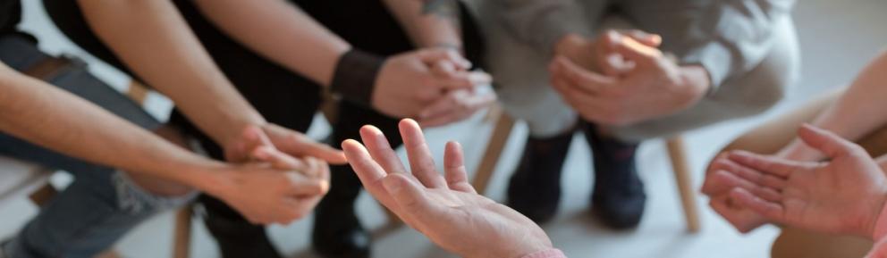 Focus on people's hands in a support group