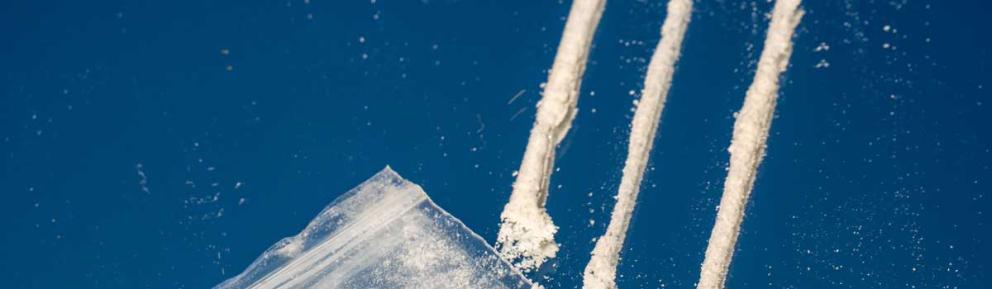 Three lines of white powder depicting some kind of drug