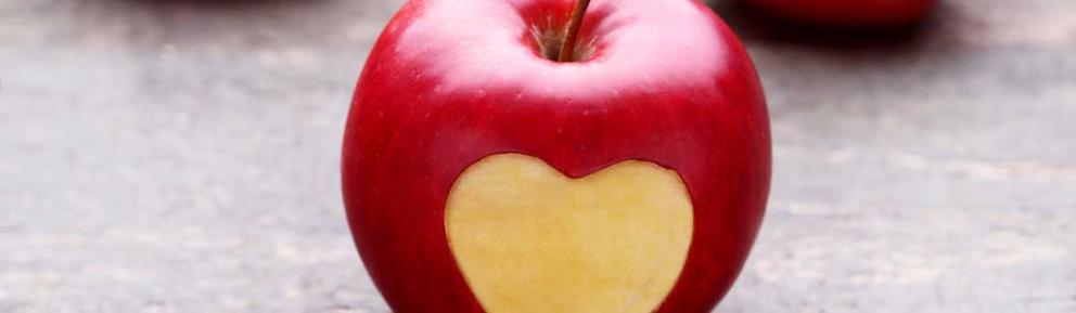Red apple with heart imprint