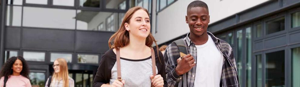 Young people with backpacks leaving a college