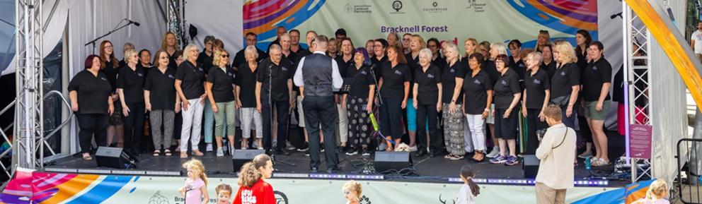 A choir on stage at the Bracknell Community Festival