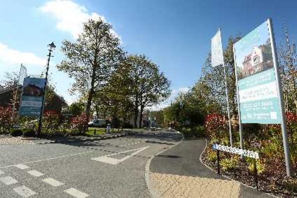 Advertising board by junction for new housing