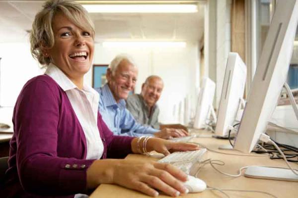 Older people smiling at computers