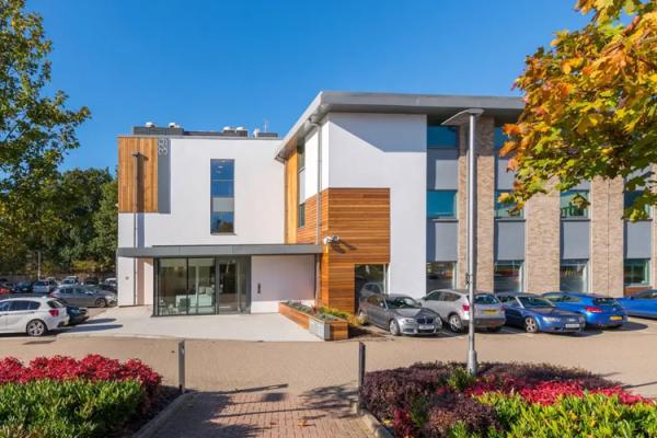 Building 329 offices in Bracknell Forest with trees and parked cars in front
