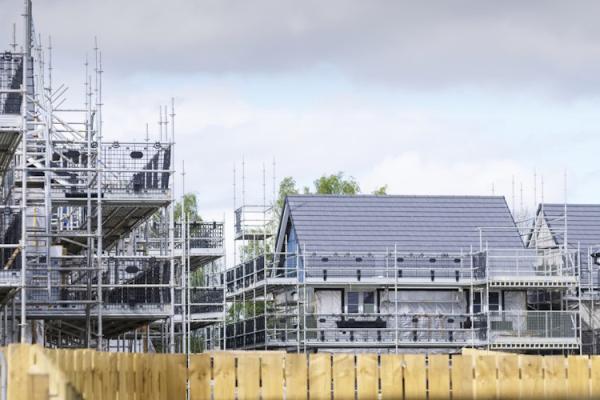 Several new homes being built, with scaffolding around them.