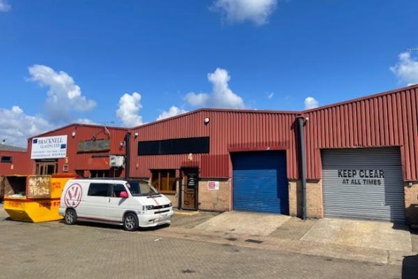 Front of industrial units with a white van parked outside