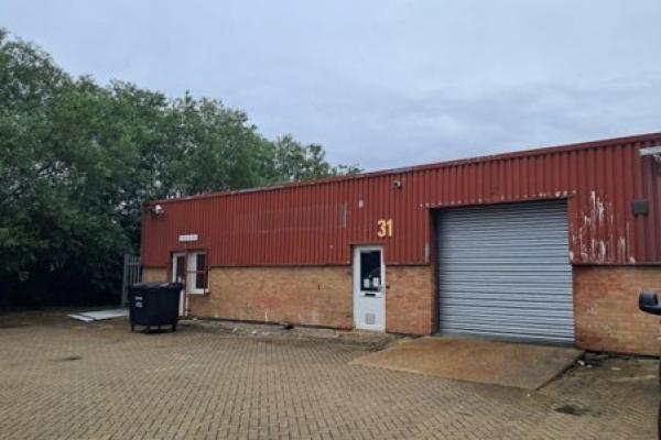 Outside of commercial unit with a garage with the number 31