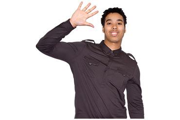Young man in a dark shirt waving and smiling.