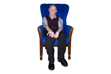 Older man sitting in a big blue chair
